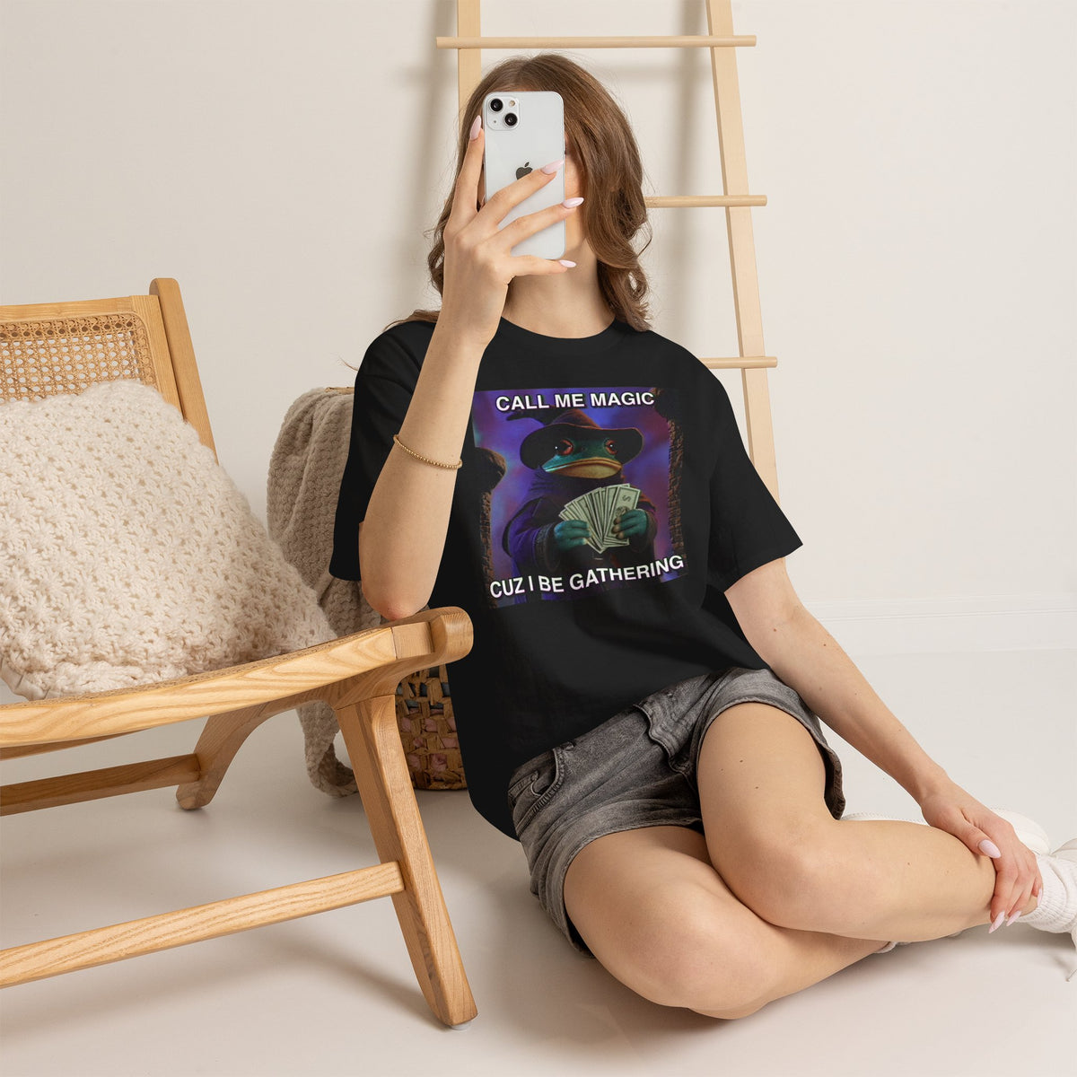 Person wearing a black t-shirt with text, sitting on the floor.