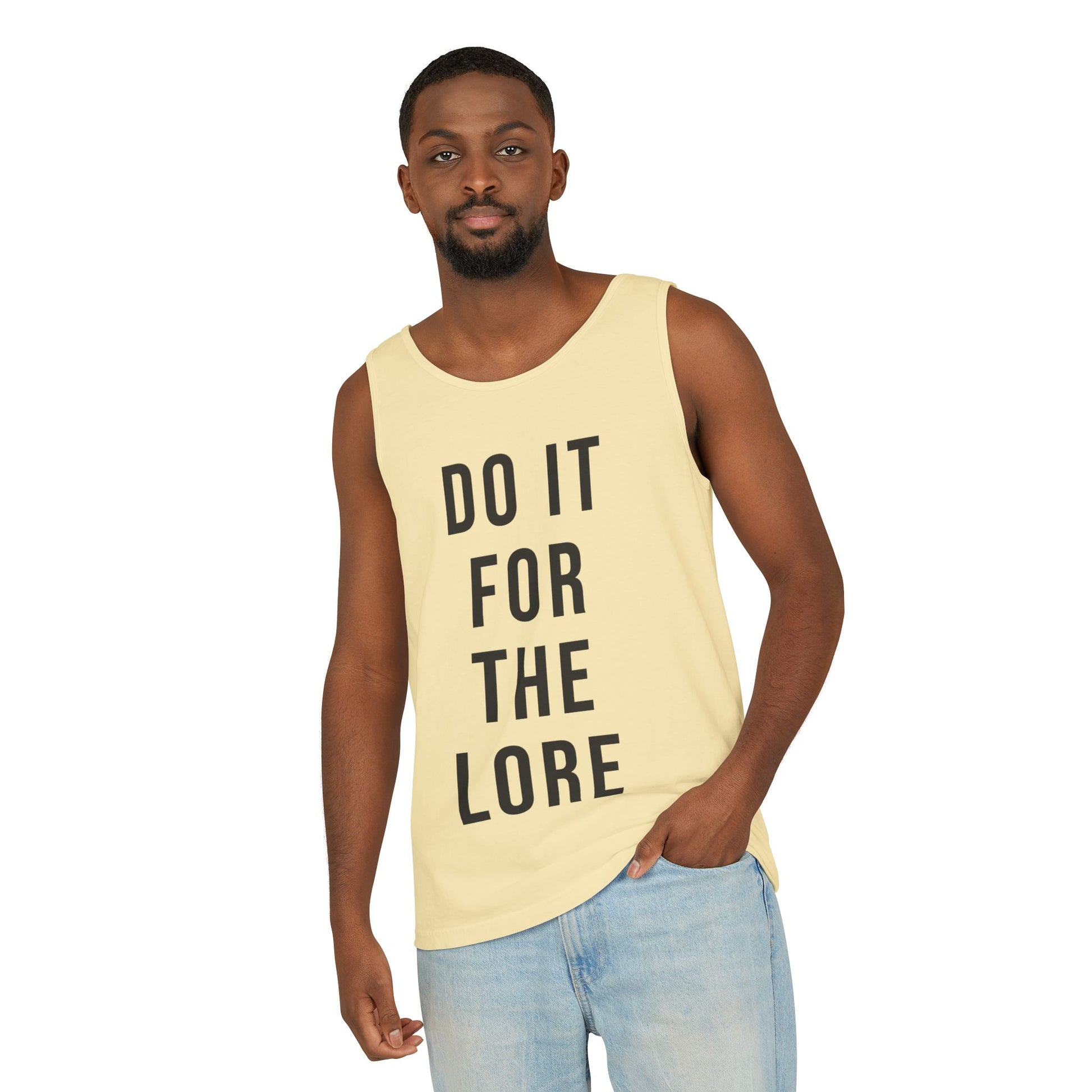 Man wearing Butter Yellow Tank Top with the bold text "DO IT FOR THE LORE" 