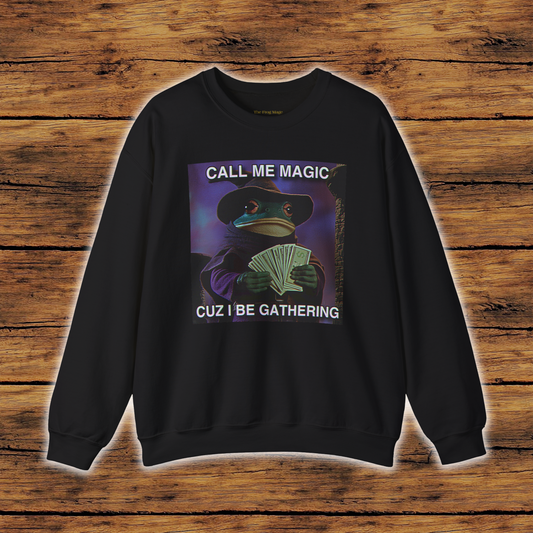 Black sweatshirt with graphic design of the frog mage holding money with the text "CALL ME MAGIC CUZ I BE GATHERING"